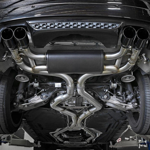A-KARCK stainless steel 2.5-inch mandrel-bend exhaust kit undercar view with quad tips and muffler.