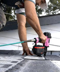 Badass 15 Degree Roofing Nailer With Smooth Low Recoil Design Built For Wire Collated Nails From Three Quarters To One And Three Quarters Inches Heavy Duty Job Site Ready Pneumatic Nail Gun in use on a roof.