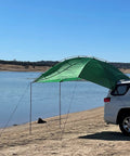 SUV Sport Multi Use Outdoor Shade Shelter Tent Camping Awning with Three Poles Two Legs attached to SUV by beach, Jolly Green