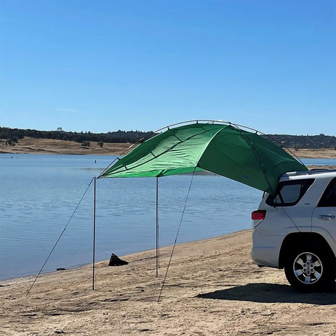 SUV Sport Multi Use Outdoor Shade Shelter Tent Camping Awning with Three Poles Two Legs attached to SUV by beach, Jolly Green