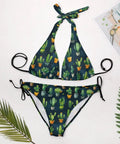 Two Piece Halter Swimsuit Set For Women With Green Cactus Flower Print Botanical Tankini Style Yacht Ready Beachwear Soft Stretch Fabric Plus Size 2XL laid out flat on white background with leaves and magazine.
