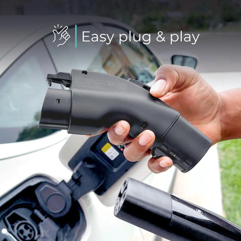 Hand holding Tesla To J1772 EV Charging Adapter Converter NACS, 48 Amp At 240V, showing easy plug-in next to car charger port.
