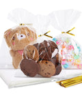 Clear Cellophane Treat Bags 5x7 Inches, 100 Pack With Gold 3 Inch Twist Ties For Cookies, Candy, Desserts, Party Favors, Gift Packaging, Baked Goods For Sweet Treats At Home, showing filled with cookies, sweets, and plush toy.