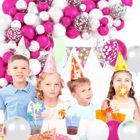 Children at party under Hot Pink And Silver Balloon Garland Arch Kit With Confetti Balloons For Weddings, Anniversary, Bachelorette Party, Birthday And Christmas Decor, Featuring Fuchsia Pink, Metallic Rose Red, White And Chrome Silver Balloons For A Party Ready Vibe.