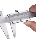 Hand holding Vernier Caliper Measuring Tool With 6 Inch Range And 0 To 150 Millimeters Manual Non Digital Calipers High Precision 0.001 Inch 0.02 Millimeters Durable Workhorse For Industrial Workshop Projects