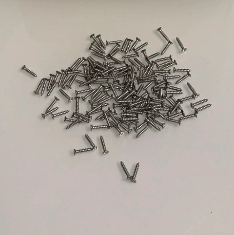 200 Pcs M2 By 10mm Stainless Steel Self Tapping Screws For Wood Plastic And Metal Projects That Are Totally Rust Proof And Built To Last Forever In Your Next DIY Build Or Furniture Fix Job, scattered screws on a white surface.