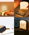 Toast Shaped Night Light With Cute Smile Face Double Or Single Side LED Toast Lamp Warm 4000K Eye Friendly Lit Glow For Bedroom Or Dorm Includes Phone Holder Cozy Room Decor And Graduation Gift For Teen Girls Ages 10 To 14, showing lamp on bedside table, next to clock.