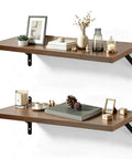 Floating Shelves Wall Mounted Set Of 2 With Heavy Duty Wood Construction Built To Last And Reinforced Anti Sag Brackets Includes 12 Hollow Wall Anchors And Complete Installation Kit For Drywall And Concrete. Walnut wood shelves with black brackets, styled with decor.