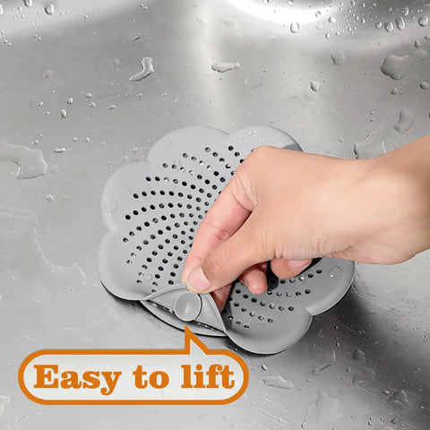 Five Pack Flower Shaped Silicone Hair Catcher Shower Drain Cover With Strong Suction Cups Killer Clog Stopper For Kitchen Bathroom Tub slick design being lifted from a sink.
