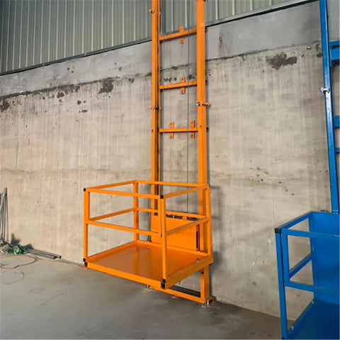 Heavy Duty Electric Lift Platform Table For Warehouse Use, Built Tough Steel Cargo Hoist With One Click Smooth Operation, Handles Up To 400kg Loads Like A Cinch Every Single Day Reliable, featuring an orange motorized lifting platform against a concrete wall.