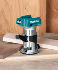 Cordless 18V LXT compact router with brushless motor, 1/4 in collet on workbench, ideal for precise wood cuts