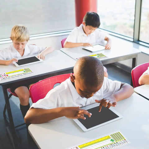 Students using tablets with Stick On Nameplate Pockets For Desks, 40 Pack, Clear Adhesive Covers Measuring 4.7 X 14.2 Inches