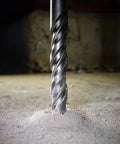 Close-up of 20 Piece SDS Plus Drill Bits And Chisels Set for Hammer Drills, drilling into concrete floor, heavy duty masonry tool