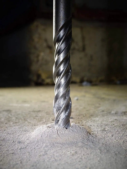 Close-up of 20 Piece SDS Plus Drill Bits And Chisels Set for Hammer Drills, drilling into concrete floor, heavy duty masonry tool