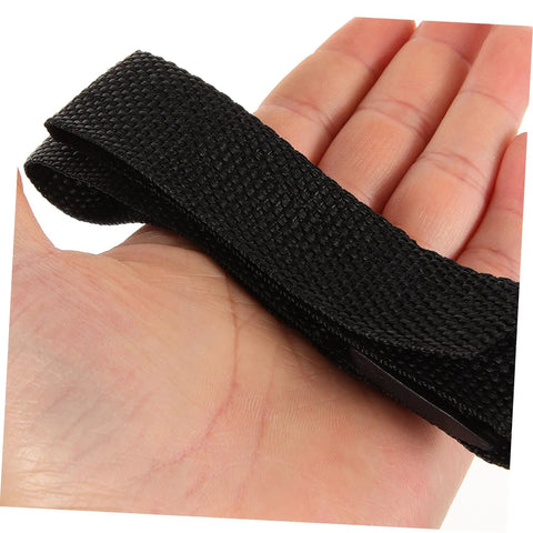 Hand holding black strap from Eight Piece Aerator Sandal Straps Replacement Set For Lawn Aerator Shoes Heavy Duty