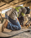 Worker wearing Wingshooter ST 6 Inch Waterproof Non Metallic Safety Toe Work Boot For Men Amber Size Nine And A Half in industrial setting.