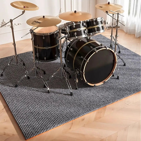 High Performance Soundproof Acoustic Foam Pads With Grippy Non Slip Backing For Piano And Drum Rooms Dead Quiet Noise Dampening Tiles For Studio And Home Theater Game Changers under a drum set on a textured rug.