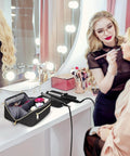 View of Shark FlexStyle Hair Tools Travel Bag With Wide Open Design And Heat Resistant Mat on a vanity with mirror and lights.