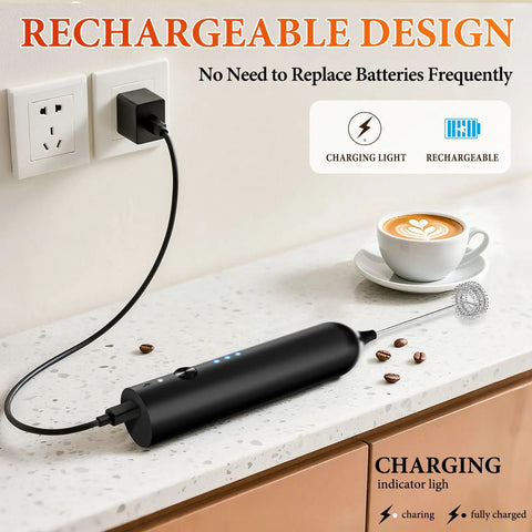 Rechargeable Handheld Milk Frother With 3 Speeds And 3 Stainless Whisks For Coffee, Matcha, Lattes, Cappuccino And More Easy No Fuss Barista Grade Foam Maker For Creamy Froth At Home Black charging on a kitchen counter next to a cappuccino.