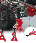 Set of four red metal RC car jack stands (3/6 ton) installed under a crawler chassis.