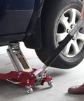 1.5 Ton Aluminum And Steel Hydraulic Floor Jack With Dual Piston Quick Lift Pump Low Profile Racing Car Jack For Vehicles Lightweight Yet Beefy 3000 Lb Capacity Red Finish lifting a car's tire