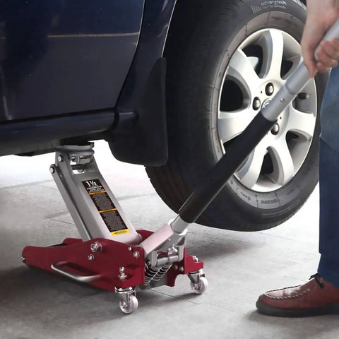 1.5 Ton Aluminum And Steel Hydraulic Floor Jack With Dual Piston Quick Lift Pump Low Profile Racing Car Jack For Vehicles Lightweight Yet Beefy 3000 Lb Capacity Red Finish lifting a car's tire