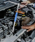 Pro Grade Half Inch Drive T Handle Socket Wrench Built Tough With Detachable Shaft in use on a car engine.