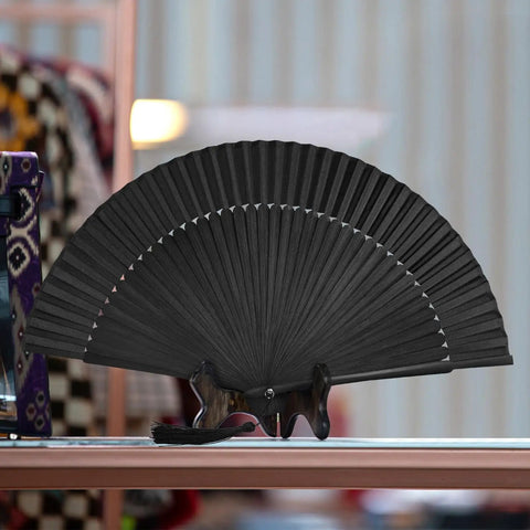 Black Hand Fan For Stage And Rave Dancers With Elaborate Design And Satisfying Snap Clack Go To Handheld Fan For Line Dancers 13 Inch Closed Size For A Bold Onstage Statement displayed open on a table.