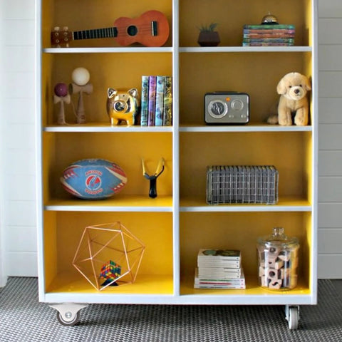 Bookshelf with toys and collectibles on Four Pack Mini Rigid 1 Inch Caster Wheels Non Swivel Fixed Casters For Furniture.