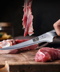7 Inch Fillet Knife Razor Sharp Boning Knife In High Carbon Stainless Steel slicing meat with precision on a wooden board.