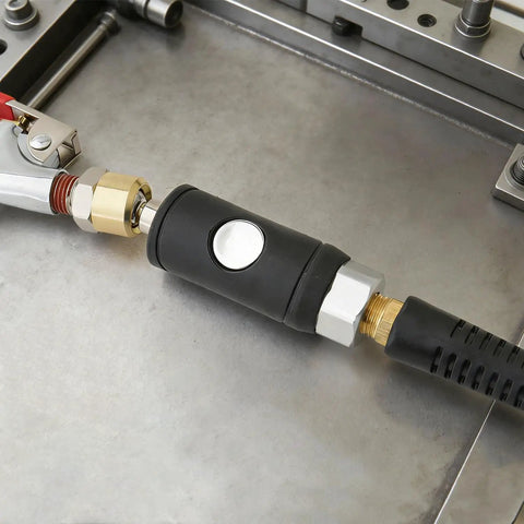 Quarter Inch Push Button Safety Air Coupler Quick Disconnect for Pneumatic Tools, Female IM Type, brass body on metal surface.