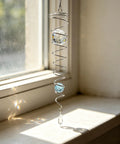 Spiral Tail Wind Spinner Gazing Ball For Indoor Outdoor Decor, 13 Inch Light Blue Crystal Glass Ball With Stainless Steel Frame, Hanging Swivel Hook, Durable Sparkle Ornament For Yard Or Patio That Pops, hanging on window