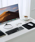Desk setup with monitor, keyboard, glasses, coffee, and Stitched Edge Non Slip Rubber Mouse Pad For Laptop And PC Use Go To Desk Mat.