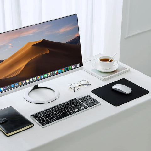Desk setup with monitor, keyboard, glasses, coffee, and Stitched Edge Non Slip Rubber Mouse Pad For Laptop And PC Use Go To Desk Mat.