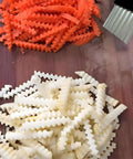 Zorveiio 2-pack crinkle cutters with black handles and stainless blades; carrot ribbons and potato crinkle-cut strips