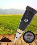 Pro Grade Soil pH And Moisture Meter With Hygrometer in use on a wooden surface near a field, features metal electrode and gauge.