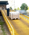 Heavy Duty Manual Pallet Jack With 1500 Kg Capacity transporting pallets on a loading ramp for warehouse material handling.