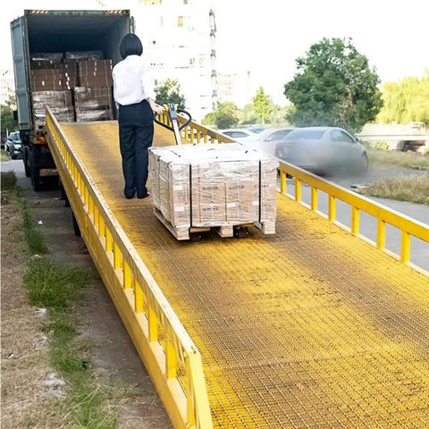 Heavy Duty Manual Pallet Jack With 1500 Kg Capacity transporting pallets on a loading ramp for warehouse material handling.