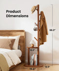 Freestanding Coat Rack With 8 Hooks And Storage Shelf, Solid Wood Base, 66.3-Inch Tall Hall Tree next to bed with hat and coat.
