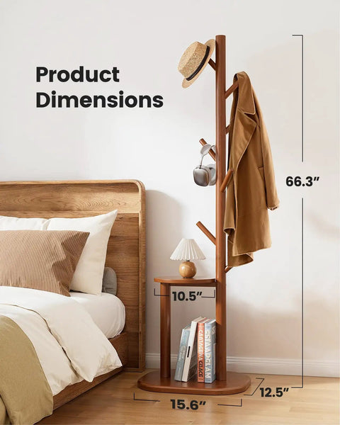 Freestanding Coat Rack With 8 Hooks And Storage Shelf, Solid Wood Base, 66.3-Inch Tall Hall Tree next to bed with hat and coat.