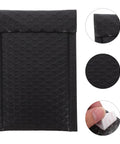 Black Bubble Mailers 12 By 18 Inch Plus 4 Inch Padded Self Seal Shipping Bags close-up of texture and sealing strip