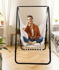 Woman relaxing in Hammock Chair With Rope Swing, Macrame Boho Hanging Chair With 2 Cushions for Indoor And Outdoor Living.