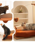 Modern Wooden Pet Hangout Haven With Swinging Toy, Built Like A Tank Oak Veneer Sofa Bed, Ultra Comfy High Resilience Foam Cushion, Scratch Proof Elevated Pad For Big Cats And Dogs with cat playing with a hanging heart toy.