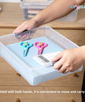 Person holding a Stackable Plastic Storage Bins With Lids Four Pack 10 Quart Clip Boxes for Crafts School Projects Office Supplies
