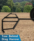 Tow Behind Drag Harrow With Pin Style Hitch 72 Inch Width Driveway Grader attached to vehicle on dirt terrain