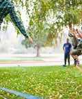 Family using Slackline Kit With Overhead Training Line, Arm Trainer, Tree Protectors during outdoor fun, 60-foot set for all ages