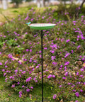 Durable 10 Inch Standing Metal Bird Bath With Stake Outdoor Garden Feeder Bowl Vintage Green Yard Decor For Patio And Lawn Weather Resistant With Easy To Clean Surface And Rust Proof Finish in garden setting.