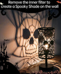 Skull Table Lamp With 3 Way Dimmable Touch Control casting skull shadows on wall, gothic decor for Halloween and Christmas. 