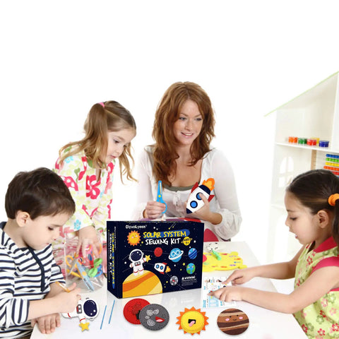 Cool Outer Space Sewing Kit For Kids DIY Felt Crafts With Nine Planet Pieces And Two Space Patterns Rocket And Astronaut A Simple Beginner Sewing Set For Boys And Girls Aged 7 To 12 shown in use by children and adult.