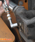 THINKWORK grease gun coupler with 90° adaptor attached to a grease fitting on heavy machinery; silver chrome.